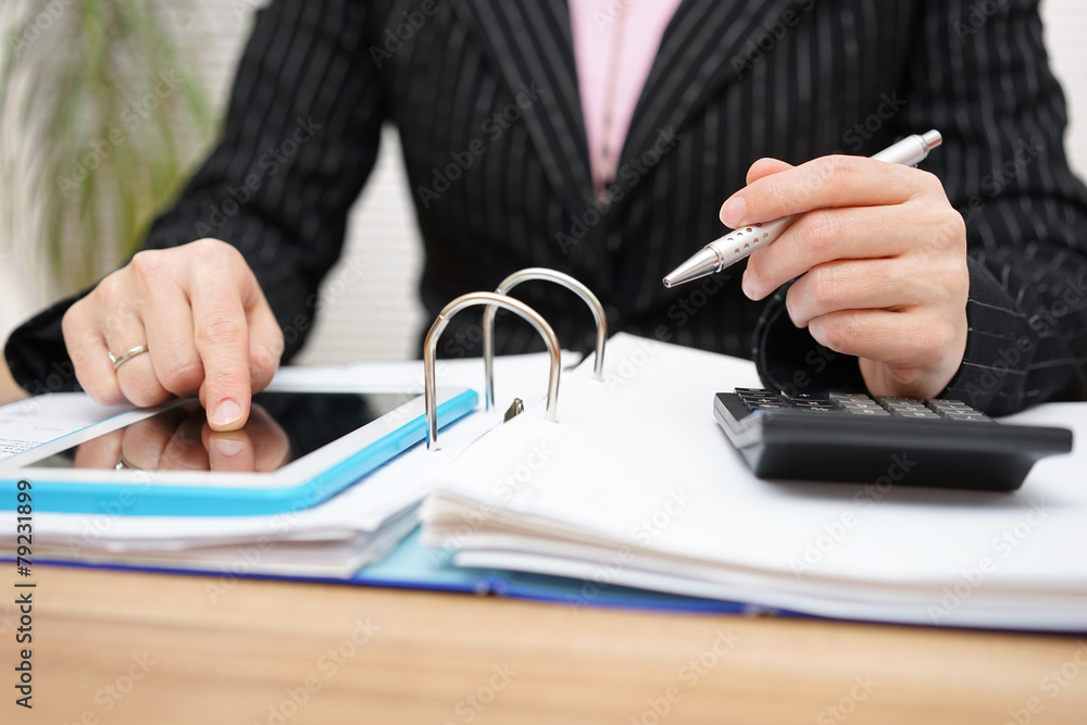 female accountant using assistance on tablet pc to complete work
