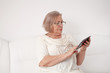 © dzejdi - Senior woman with a digital tablet
