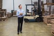 © WavebreakmediaMicro - Manager holding clipboard in warehouse