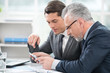 © Friends Stock - Two businessmen working with tablet computer
