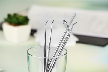 Canvas Print - Dentist tools in glass table close up