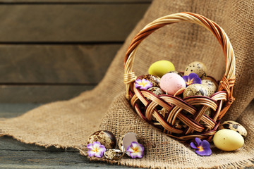 Wall Mural - Bird eggs in wicker basket with decorative flowers