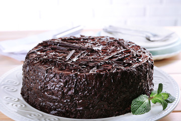 Wall Mural - Tasty chocolate cake with mint on table close up