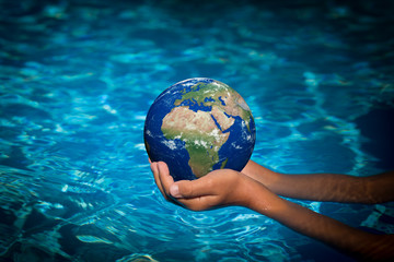 Child holding Earth planet in hands