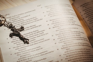 Open bible and silver crucifix