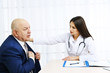 © Africa Studio - Young female doctor receiving patient in her office