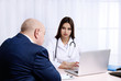 © Africa Studio - Young female doctor receiving patient in her office