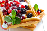 Fototapeta  - Belgian waffles with yogurt and berries
