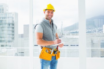 Poster - Manual worker writing on clipboard in building