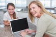 © WavebreakmediaMicro - Happy mother using laptop with her daughter