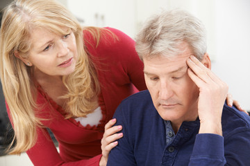 Mature Woman Comforting Man With Depression