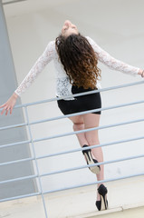 Woman is leaning against an iron railing