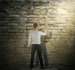 Wall Mural - Man is Touching a Cross