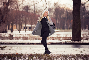 Beautiful blonde girl walking on the street