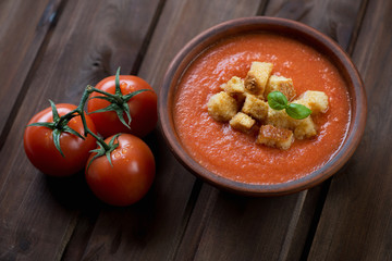 Wall Mural - Ceramic bowl with Gazpacho over rustic wooden background