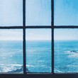 A view of the ocean from an old window.