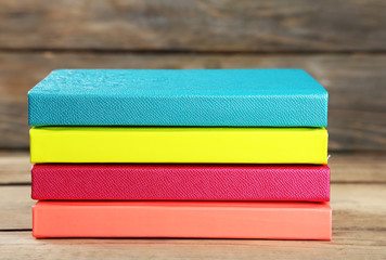 Sticker - Colorful notebooks on old wooden table