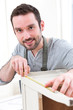 © Production Perig - Young attractive carpenter working in his workshop