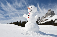 Funny Snowman Against Swiss Alps