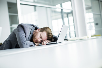 Tired young man in the office