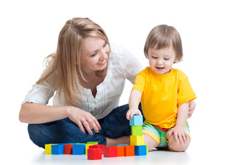 kid boy and mother play together with construction set toy