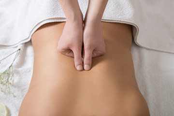 Woman Receiving Back Massage in Spa Center