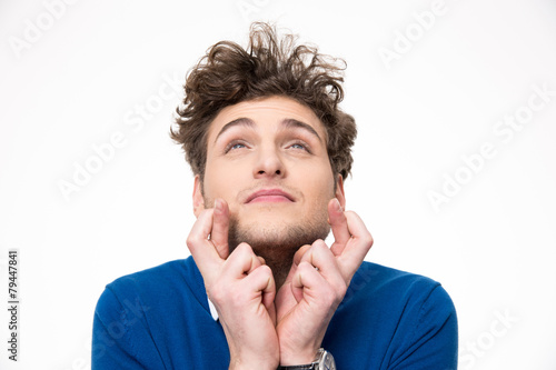 Fotografia, Obraz Young handsome man with crossed fingers over white background