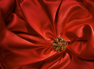 Jewelry Shape over Red Silk Cloth Background, Fabric Folds
