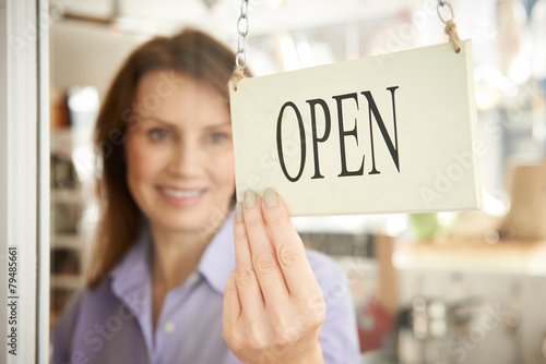Fotografie, Obraz Store Owner Turning Open Sign In Shop Doorway