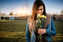 Attractive Young Woman With Yellow Rose