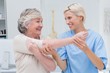 © WavebreakmediaMicro - Happy nurse assisting patient in raising arm