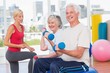 © WavebreakmediaMicro - Happy senior couple lifting dumbbells