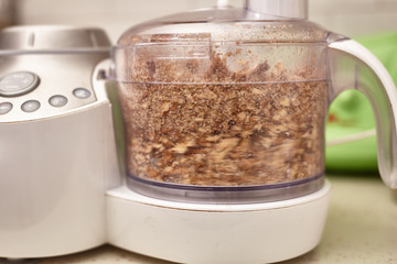 Wall Mural - Crushed kernel walnuts in food processor