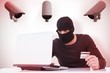 © WavebreakMediaMicro - Burglar doing online shopping with laptop and credit card