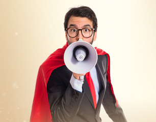 Wall Mural - Businessman dressed like superhero shouting by megaphone