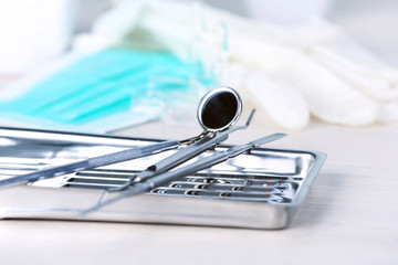 Canvas Print - Dentist tools in metal tray on table close up