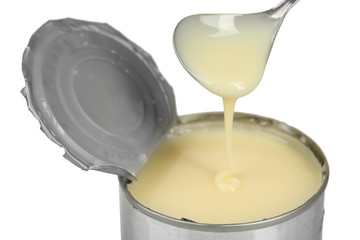 Wall Mural - Tin can of condensed milk with spoon close up