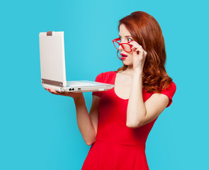 Wall Mural - Surprised redhead girl with laptop