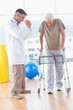 © WavebreakMediaMicro - Senior man on zimmer frame with therapist