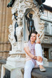 © Alliance - Young woman sitting in loggia dei lanzi in florence, italy
