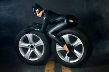 Sexy Female In Black Catwoman Costume On Motorcycle