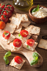 Wall Mural - crackers with soft cheese and tomatoes. healthy appetizer