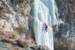 climber ascends the vertical icefall