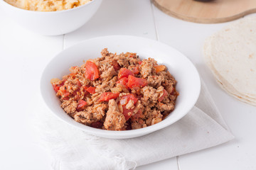 fried ground meat with tomatoes ready for tacos