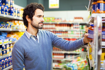 attractive man shopping in a supermarket