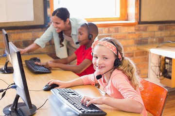 Wall Mural - Cute pupils in computer class with teacher