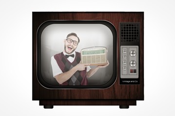 Poster - Composite image of geeky hipster holding a retro radio