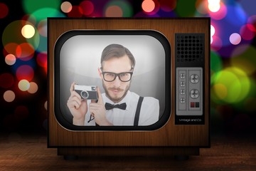 Poster - Composite image of geeky hipster holding a retro camera