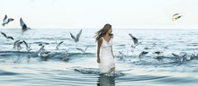 Beautiful Woman And Seaguls On The Beach