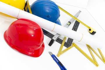 Colorful helmets and tools for construction drawings and buildin